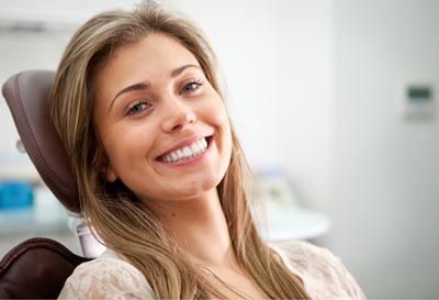 woman smiling after her cosmetic dentistry appointment at Bonham Dental Arts