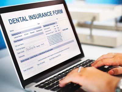 patient filling out dental insurance form