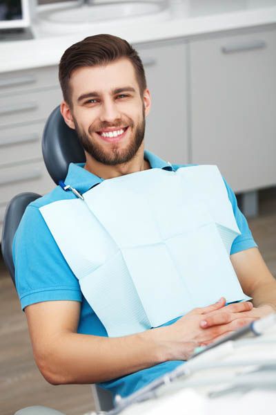 man smiling during his dental appointment at Bonham Dental Arts