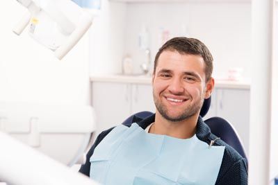 Man smiling during his dental appointment at Bonham Dental Arts