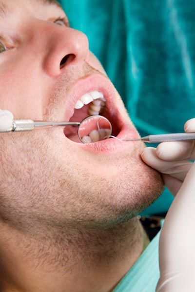 man getting his teeth cleaned at Bonham Dental Arts