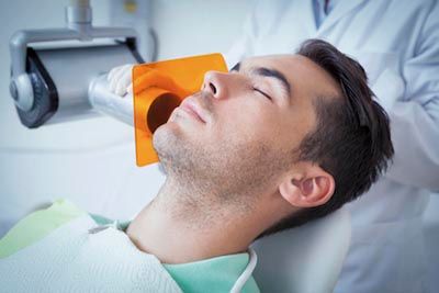 man sleeping during his dental procedure thanks to sedation